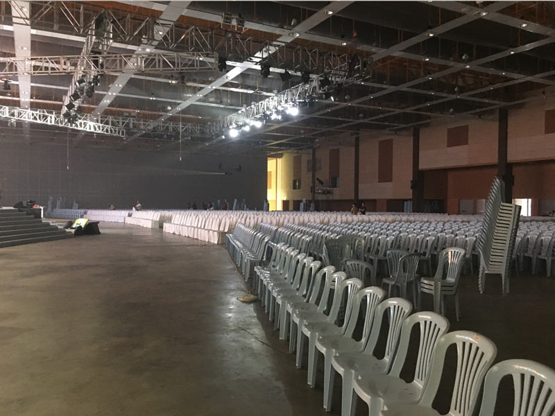 Chairs laid out under an indoor canopy build in a hall
