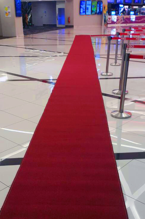 Maroon walking carpet runner laid at an event entrance