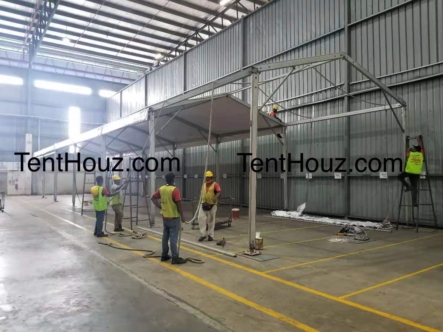 Row of shelter tent bays set up on open ground